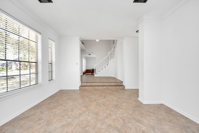 spare room with light tile patterned floors, baseboards, stairway, and ornamental molding