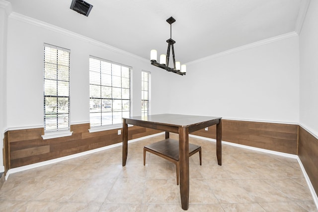 dining area featuring a wainscoted wall, visible vents, and crown molding