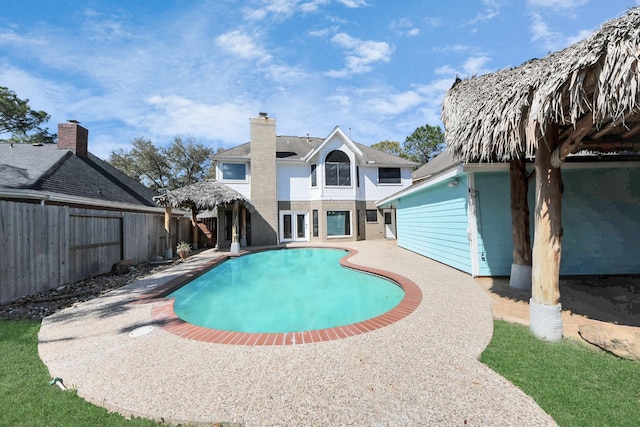 view of pool featuring a fenced backyard, a fenced in pool, and a patio