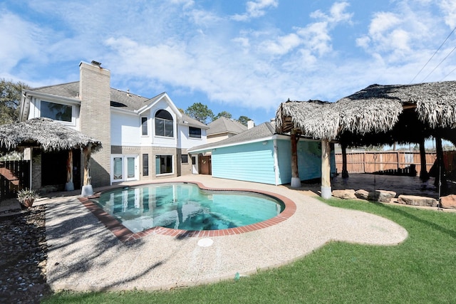 view of pool featuring a patio and fence