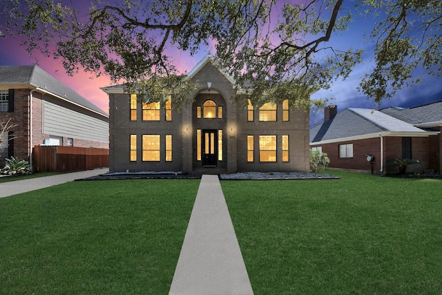 view of front facade with a front yard and fence