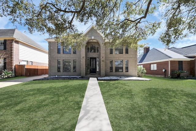 view of front of home featuring a front yard and fence