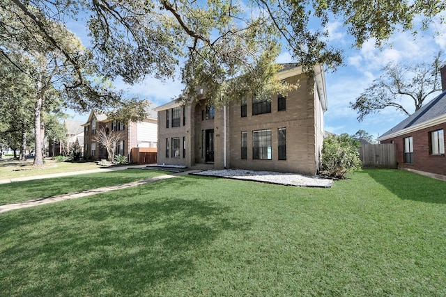 view of front facade featuring a front lawn and fence