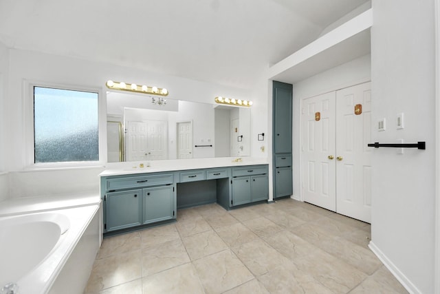 bathroom with double vanity, a garden tub, an enclosed shower, and a sink