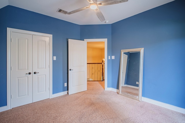 unfurnished bedroom with light carpet, a closet, visible vents, and baseboards