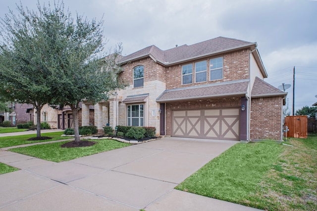 view of front of home with a front yard, brick siding, driveway, and roof with shingles