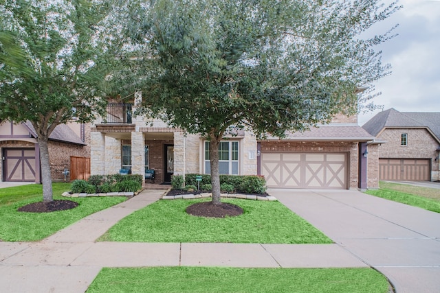 view of front of home featuring a garage, stone siding, brick siding, and driveway