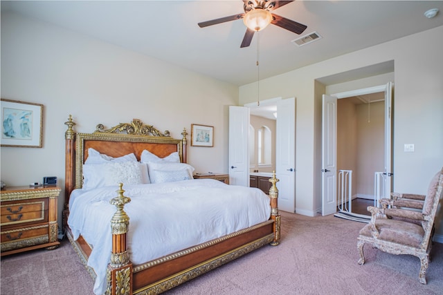 bedroom with carpet flooring, visible vents, baseboards, a ceiling fan, and attic access