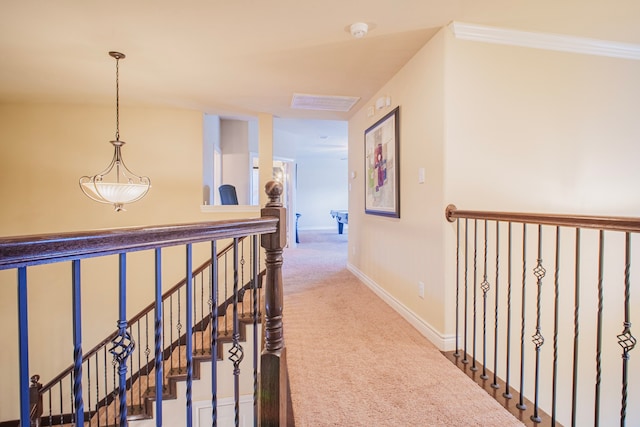 hall with carpet flooring, an upstairs landing, and baseboards