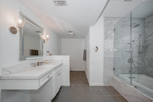 full bathroom with baseboards, visible vents, tiled shower / bath combo, a textured ceiling, and vanity