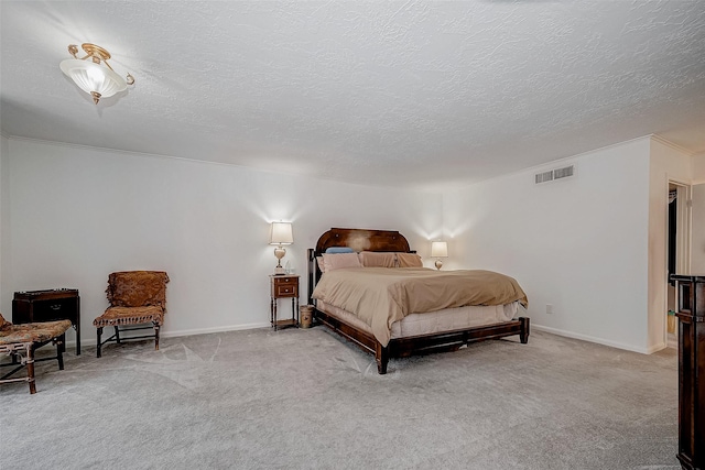 bedroom featuring light carpet, visible vents, baseboards, and a textured ceiling