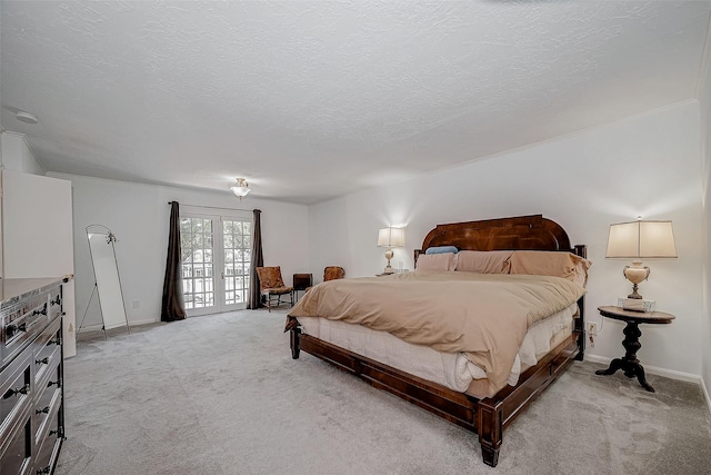 bedroom with french doors, light carpet, a textured ceiling, and baseboards