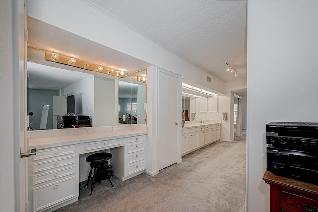 bathroom with visible vents, vanity, and a textured ceiling