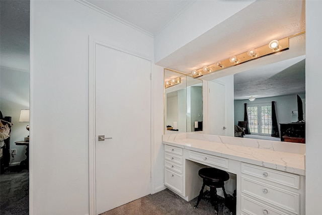 ensuite bathroom featuring crown molding, vanity, ensuite bath, and a textured ceiling