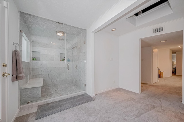 full bathroom featuring a stall shower, visible vents, crown molding, and baseboards