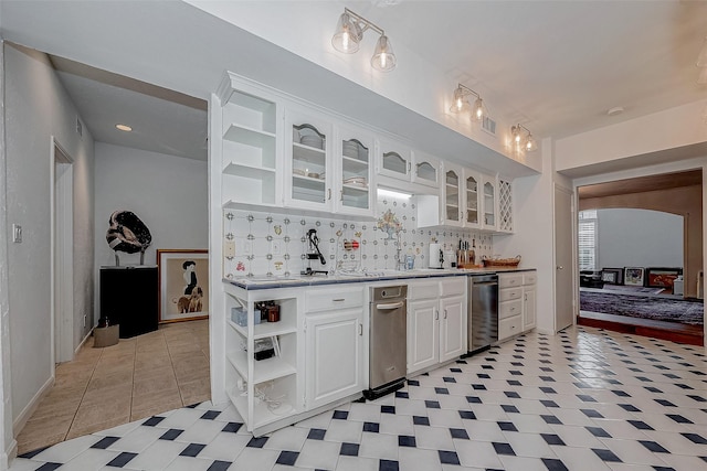 kitchen with white cabinets, decorative backsplash, glass insert cabinets, light countertops, and open shelves