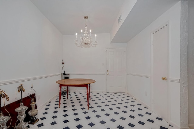 dining room with an inviting chandelier, visible vents, and light floors