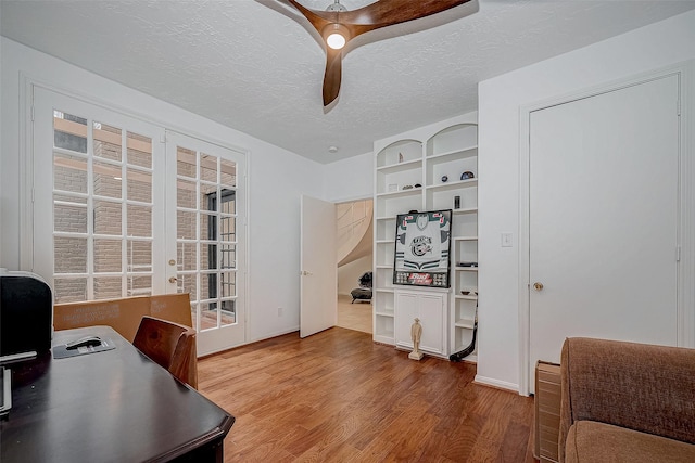 office space with french doors, plenty of natural light, a textured ceiling, and wood finished floors