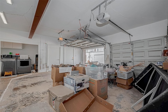 garage featuring separate washer and dryer and a garage door opener