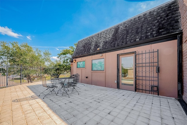 view of patio with outdoor dining area and fence