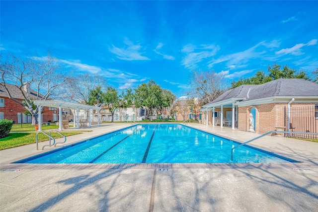 community pool with a residential view, fence, a pergola, and a patio