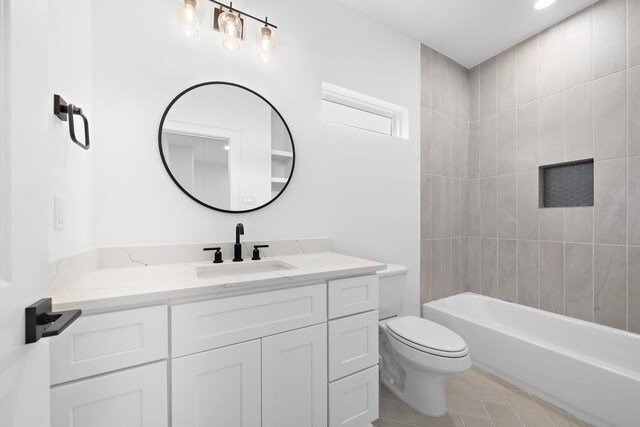 bathroom featuring shower / washtub combination, tile patterned flooring, vanity, and toilet