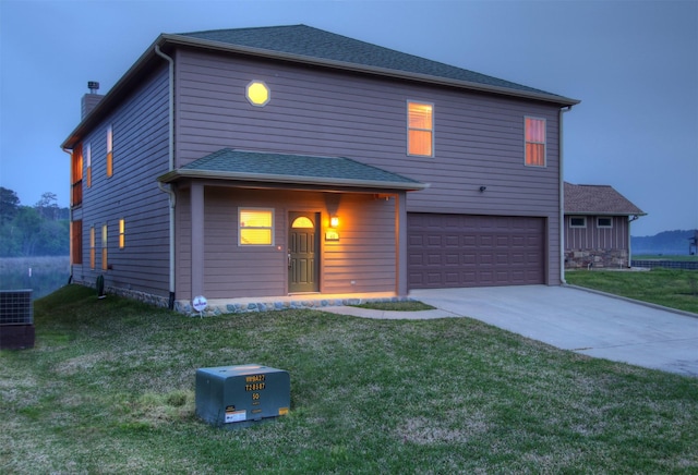 traditional-style house featuring a garage, a chimney, cooling unit, and a lawn