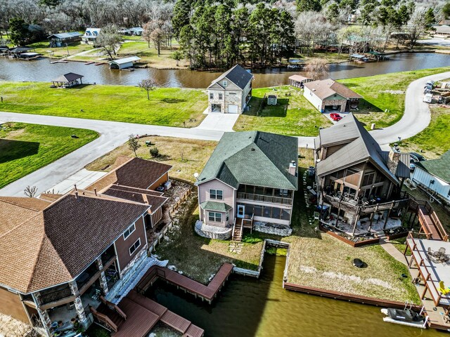 birds eye view of property featuring a water view and a residential view