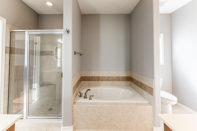 bathroom featuring toilet, a stall shower, vanity, tile patterned flooring, and a bath