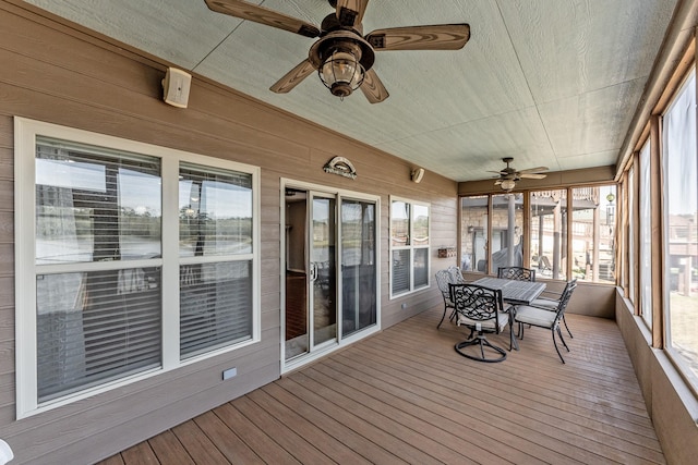 unfurnished sunroom featuring a ceiling fan