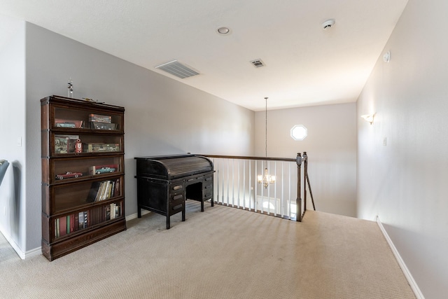 interior space with visible vents, baseboards, carpet, an upstairs landing, and a chandelier