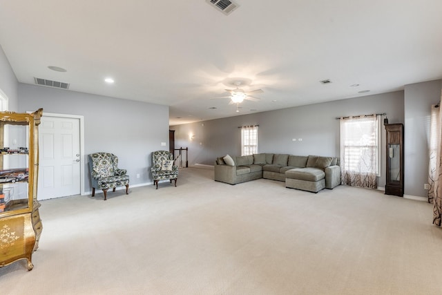 living room featuring light carpet, baseboards, and visible vents