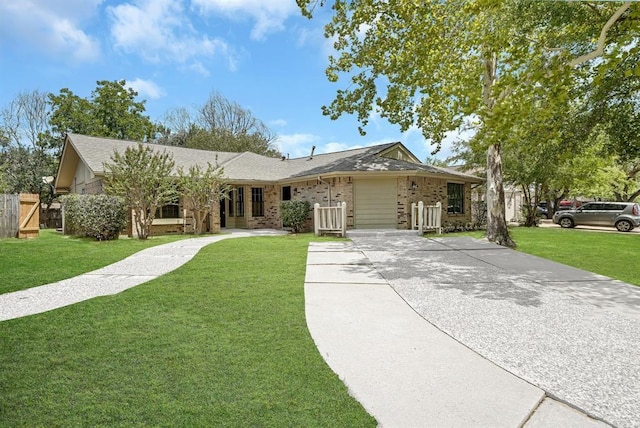 ranch-style house with driveway, a front lawn, and brick siding