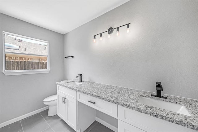 full bathroom featuring double vanity, toilet, a sink, and tile patterned floors