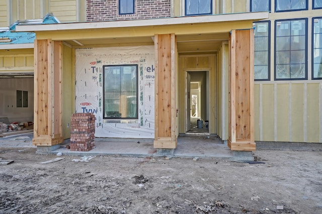 property entrance featuring brick siding