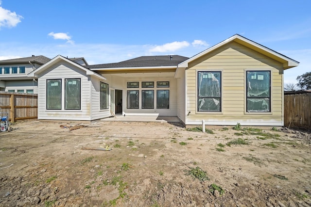 back of house with fence and a patio