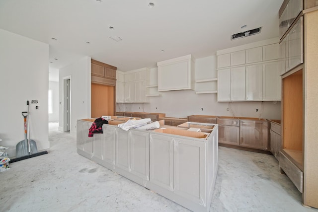 kitchen featuring concrete flooring and a center island