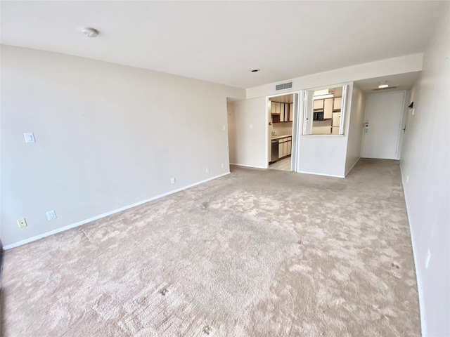 empty room featuring carpet flooring, visible vents, and baseboards