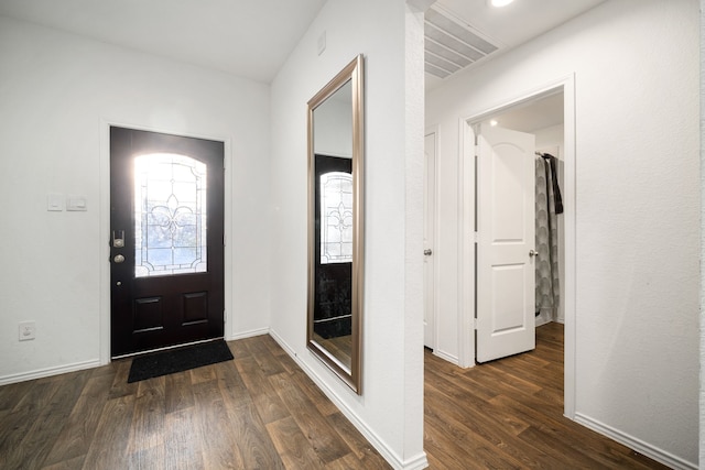 entryway featuring dark wood-style floors, visible vents, and baseboards