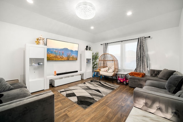 living room with a notable chandelier, wood finished floors, and recessed lighting