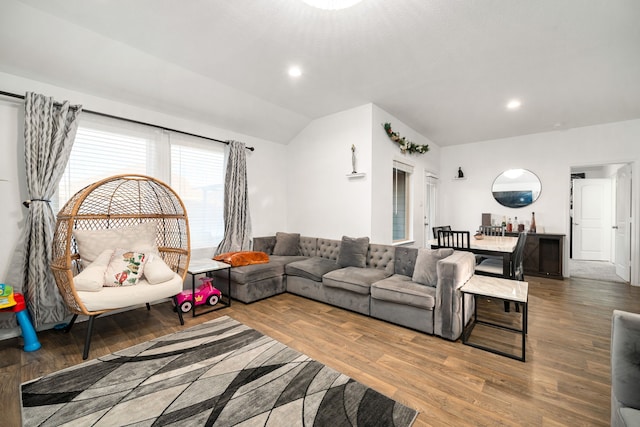 living room featuring lofted ceiling, wood finished floors, and recessed lighting