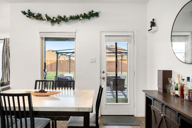 dining room with plenty of natural light and wood finished floors