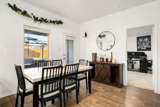 dining space with dark wood-type flooring