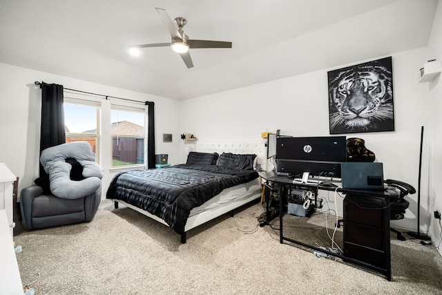 carpeted bedroom featuring lofted ceiling and a ceiling fan