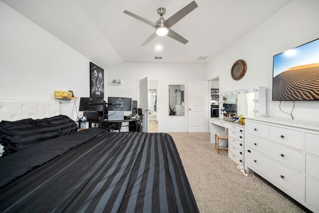 carpeted bedroom featuring lofted ceiling, ensuite bath, ceiling fan, and visible vents