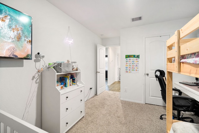 office area with visible vents and light colored carpet