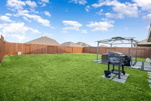 view of yard with a fenced backyard and a pergola