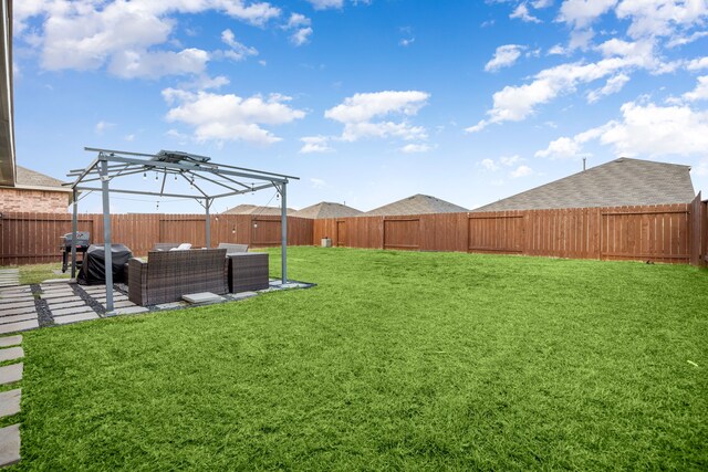 view of yard with a patio area, a fenced backyard, and an outdoor living space