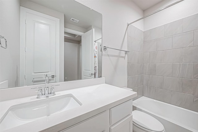 full bathroom with washtub / shower combination, toilet, vanity, and visible vents