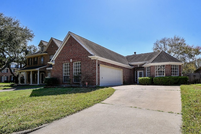 traditional-style house with a garage, a front lawn, concrete driveway, and brick siding